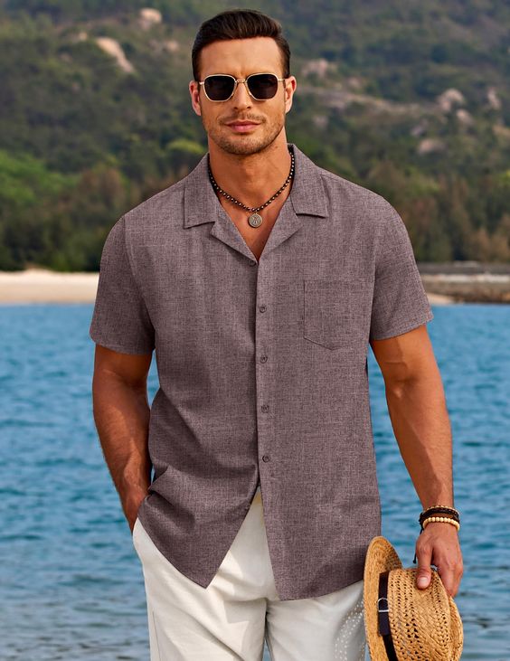 a man wearing gray cuban collar shirts and sunglasses