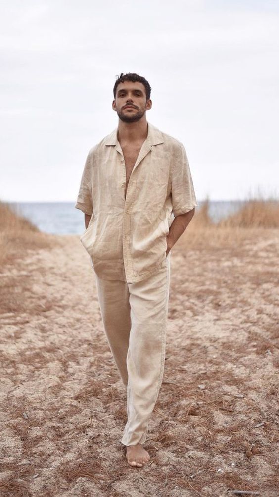 man standing in the desert wearing a beige linen shirt paired with trousers